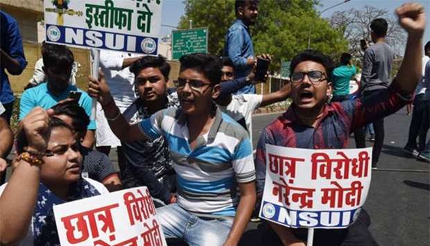 Members of the National Students Union of India hold placards as they shout slogans during a protest against Education Minister Prakash Javadekar in New Delhi on Friday.