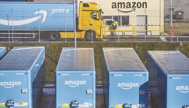 A truck pulling an Amazon Prime branded cargo container waits beside the entrance gate at Amazon.comu2019s new fulfilment centre in Kolbaskowo, Poland. Trump has charged that Amazon doesnu2019t pay enough in state and local sales taxes, hurts retailers and gets an unfair edge on the back of the US Postal Service.
