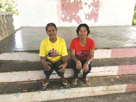 Corazon Vegafria and Lettie Garcisa pose in the village of Pamantingan.