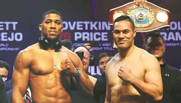 Britainu2019s Anthony Joshua (L) and New Zealandu2019s Joseph Parker attend a weigh-in photocall at the Motorpoint Arena in Cardiff yesterday.