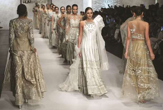 Models present creations by Pakistani designer Sania Maskatiya late on Friday.