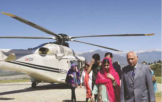 Malala is seen with the principal of all-boys Swat Cadet College Guli Bagh, during her hometown visit, some 15km outside of Mingora.