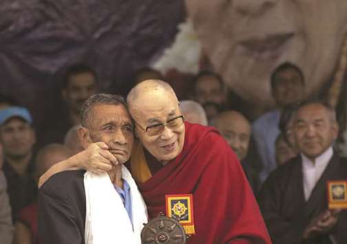 The Dalai Lama honours member of Assam Rifles Naren Chander Dass during the u201c Thank you India-2018u201d function at Tsugla Khang Temple in Dharamshala yesterday.