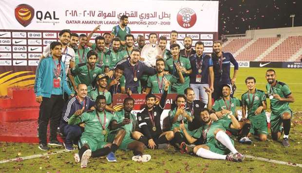 Al Nasr players celebrate with the trophy after winning the #Qatar Amateur League.