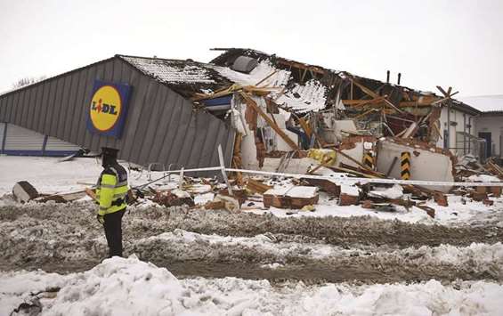 A police officer is seen at the scene of extensive damage done by looters to the Lidl supermarket at Tallaght, near Dublin.