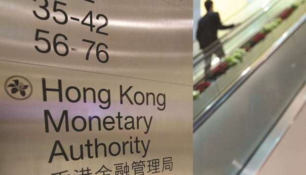 A man walks past a directory board of the Hong Kong Monetary Authority. The HKMA said Wednesday the exchange rate is weakening on expectations of faster US rate hikes and a widening spread. Rates will rise when the Hong Kong dollar reaches the weak end of its band, which shouldnu2019t cause any particular concern, the authority said.