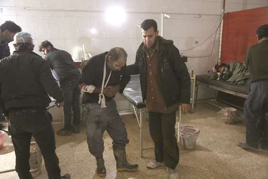 Wounded Syrians are seen as they wait to receive treatment at a make-shift hospital following government bombardments on the besieged rebel-held town of Hamouria in the eastern Ghouta region on the outskirts of the capital Damascus.