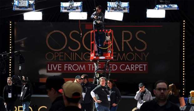 Workers and staff prepare the red carpet on the eve of this Sundays 90th Oscars ceremony, in Hollywood