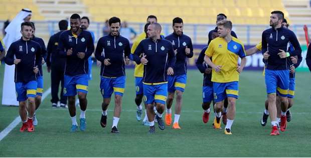 Al  Gharafau2019s Wesley Sneijder (C) warms up with his teammates during a training session in Doha yesterday. Al Gharafa will clash with Saudi Arabiau2019s Al Ahli in a Group A AFC Champions League match today. At bottom, the Al Ahli team train for the match. PICTURES: Anas Khalid