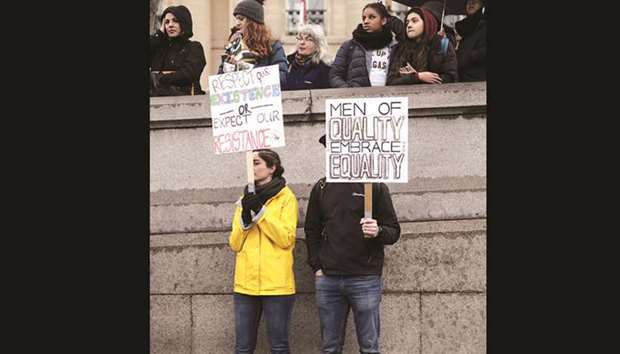 Protesters hold placards as they demonstrate during the March4Women event in central London yesterday.