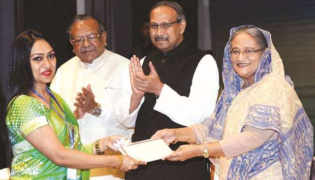 Prime Minister Sheikh Hasina presenting the Bangabandhu Fellowship award to a researcher as others look on, in Dhaka yesterday.