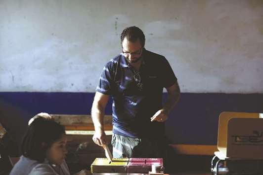 A man casts his vote during the municipal and parliamentary elections at a polling station in San Salvador, El Salvador, yesterday.