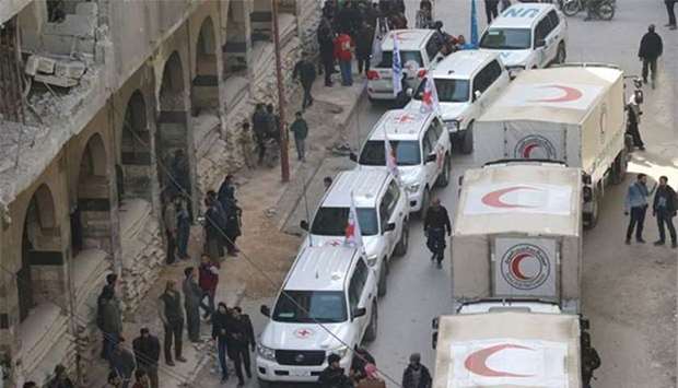 Trucks from the Syrian Red Crescent and humanitarian partners are seen in Ghouta on Monday.