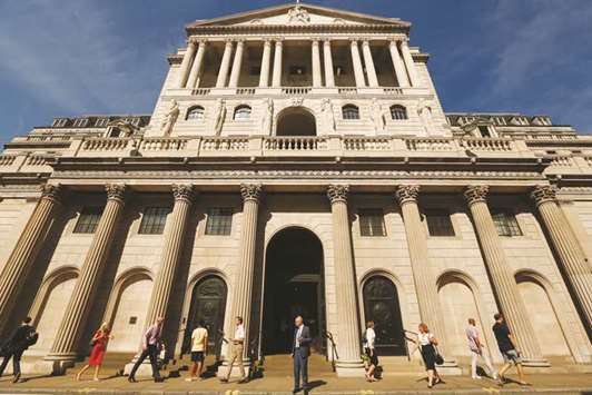 Pedestrians walk past the Bank of England building in the City of London (file). Britainu2019s services businesses perked up in February after the weakest start to the year in almost a decade, according to a survey that reinforced market bets that the BoE will raise interest rates again in May.