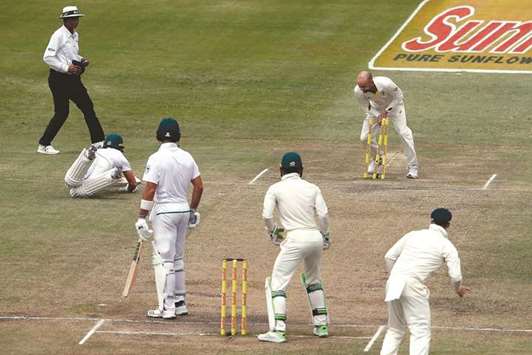 Australian players celebrate the wicket of South Africau2019s Kagiso Rabada during the third day of the first Test at Kingsmead Stadium, Durban. (Reuters)