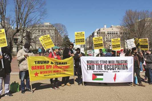 Demonstrators hold placards as they attend a protest outside the AIPAC Policy Conference in Washington yesterday in this picture obtained from social media.