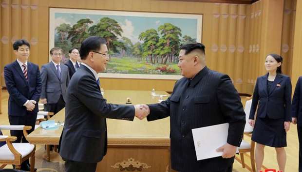 North Korean leader Kim Jong Un shakes hands with Chung Eui-yong who is leading a special delegation of South Korea's President