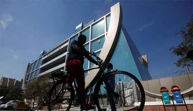 A man rides his bicycle past India's Central Bureau of Investigation (CBI) headquarters building in New Delhi on Tuesday.