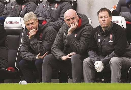 Arsenal manager Arsene Wenger (left) and assistant manager Steve Bould (centre) look dejected during their EPL match against Brighton & Hove Albion in Brighton, Britain. (Reuters)