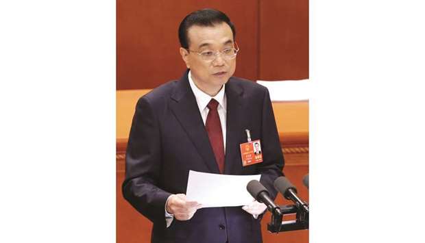 Chinese Premier Li Keqiang delivers a speech at the opening session of the National Peopleu2019s Congress at the Great Hall of the People in Beijing. Li announced on Monday in his annual work report that Beijing has cut the budget deficit target to 2.6% of gross domestic production from 3% in 2017.