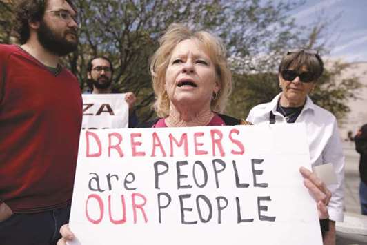 Members of the Border Network for Human Rights and Borders Dreamers and Youth Alliance protest outside a federal courthouse in El Paso, Texas, on Monday to demand that Congress pass a Clean Dream Act.