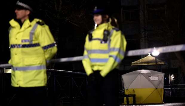 Police officers stand guard beside a cordoned-off area, after former Russian military intelligence officer Sergei Skripal, who was convicted in 2006 of spying for Britain, became critically ill after exposure to an unidentified substance, in Salisbury, southern England