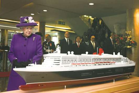 Queen Elizabeth II looks at a model of the RMS Queen Mary 2 transatlantic ocean liner during a visit to the International Maritime Organisation (IMO) in London yesterday to mark the 70th anniversary of its formation. As a specialised agency of the United Nations, the IMO is the global standard-setting authority for the safety, security and environmental performance of international shipping. The organisation has 173 member states and is the only United Nations agency to be headquartered in the UK.