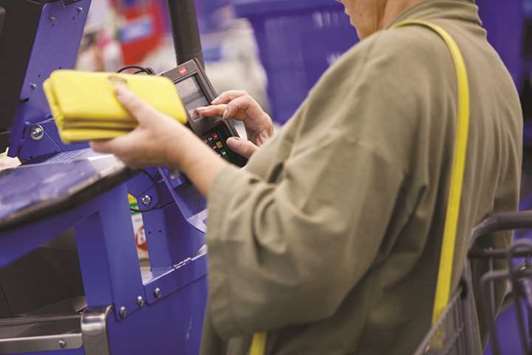 A customer uses a credit card terminal to complete a purchase at a Wal-Mart Stores location in Burbank, California (file). A Fed survey found the 18 to 24 demographic preferred to pay cash more than others. And if they do carry a card, it tends to be of the prepaid or debit variety, TD Bank found.