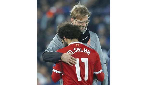 Liverpool manager Juergen Klopp hugs midfielder Mohamed Salah after the Champions League match against FC Porto. (Reuters)