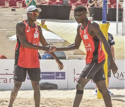 Qataru2019s Cherif Younousse (left) and Ahmed Tijan during their match against Nico Beeler and Marco Krattiger of Switzerland at the FIVB Katara Beach Volleyball Cup yesterday. PICTURES: Jayaram
