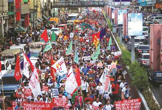 Womenu2019s rights activists display placards and streamers while marching during a celebration of the International Womenu2019s Day in Quiapo city, Metro Manila, Philippines, yesterday.