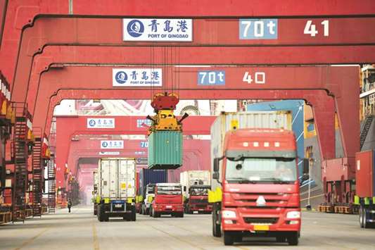 Trucks transport containers at Qingdao port in Shandong province. Chinau2019s exports rose 24.4% in January-February, eclipsing 10.8% in December and up from  single-digit growth in the same period last year.