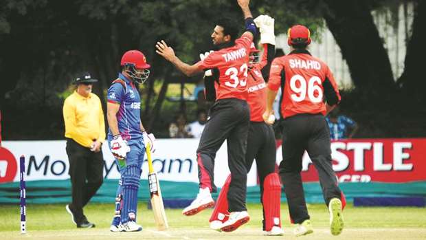 Hong Kong bowler Tanwir Afzal (centre) celebrates after dismissing Afghanistan batsmanu2019s Javed Ahmadi (left) during the ICC Cricket World Cup Qualifier in Bulawayo, Zimbabwe, yesterday. (ICC)
