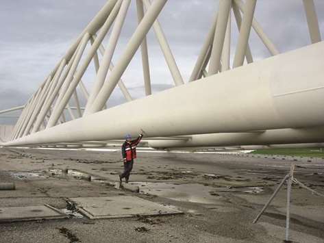 PROTECTION: The storm barrier near Rotterdam dwarfs engineer Peter Peerson u2013 each gate is as long as the Eiffel Tower is high.