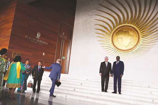 AU chairman Moussa Faki with Tillerson stand for news photographers, before being joined by other diplomats, following their meeting at AU headquarters in Addis Ababa.