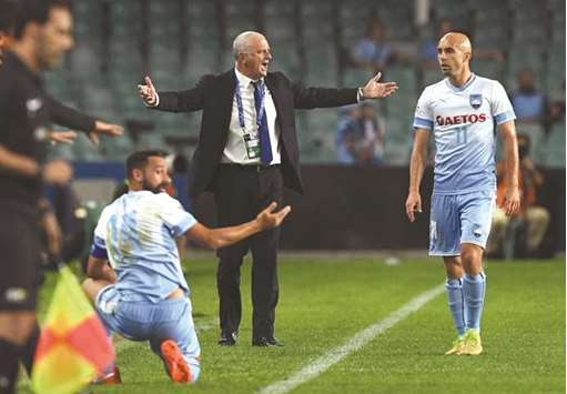 Sydney FC coach Graham Arnold (C) reacts with players Alex Brosque (L) and Adrian Mierzejewski (R) during their AFC Champions League match against Kashima Antlers in Sydney. He will take over as coach of the Australian team after this yearu2019s World Cup in Russia.