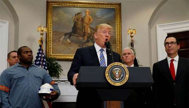 President Donald Trump, surrounded by workers from the steel and aluminum industries, makes an announcement about placing tariffs on steel and aluminum imports, at the White House in Washington on Thursday.