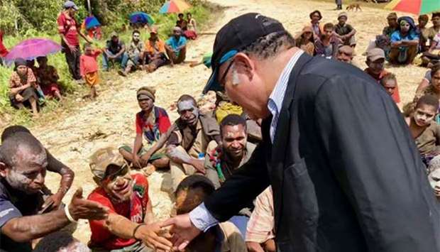 Prime Minister of Papua New Guinea, Peter O'Neill, greets villagers in Tari, in Hela province after an earthquake hit the remote area in the highlands of Papua New Guinea.
