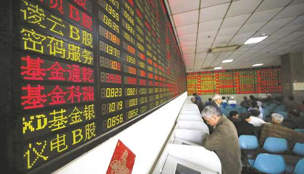 Investors look at computer screens showing stock information at a brokerage house in Shanghai. After Trumpu2019s announcement on proposed steel and aluminium imports last week, Chinau2019s Shanghai Composite Index slipped 0.6%.