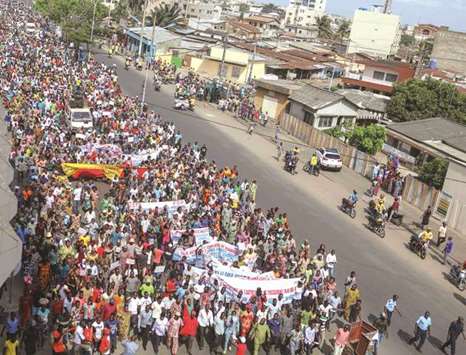 People march along a street during a protest against the current presidentu2019s free-market reforms in Cotonou, yesterday.