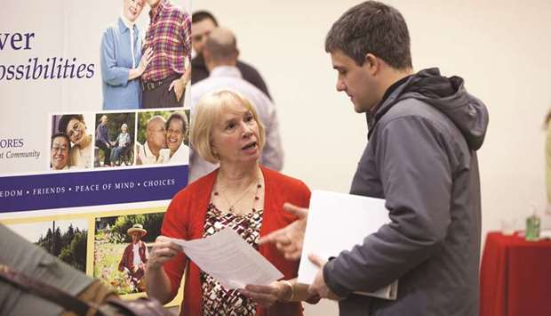 A job seeker (right) speaks with a company representative during a Choice Career Fair event in Seattle, Washington. Nonfarm payrolls jumped by 313,000 jobs last month, boosted by the largest gain in construction jobs since 2007, the Labour Department said yesterday.