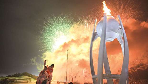 Wheelchair curler Seo Soon-Seok and curler Kim Eun-jung of South Korea are seen after lighting the Paralympic Cauldron during the Opening Ceremony of the Pyeongchang 2018 Winter Paralympics in Pyeongchang, South Korea, yesterday.