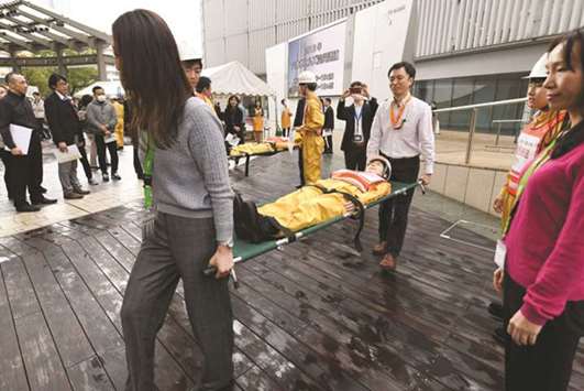 People receive first-aid lessons during a disaster drill at the Roppongi Hills shopping complex in Tokyo. About 800 residents, office and shop workers at and around the Roppongi Hills shopping complex took part in a disaster drill one day before the anniversary of the magnitude 9.0 earthquake in Japan in 2011, which triggered a deadly tsunami and nuclear disaster.