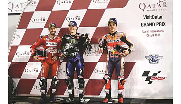 Monster Energy Yamaha MotoGPu2019s Maverick Vinales of Spain (C), who clocked the best time ahead of Mission Winnow Ducatiu2019s Andrea Dovizioso (L) and Repsol Hondau2019s Marc Marquez of Spain (R), poses with them at the end of the qualification session of the VisitQatar Grand Prix at the Losail International Circuit yesterday. PICTURE: Noushad Thekkayil