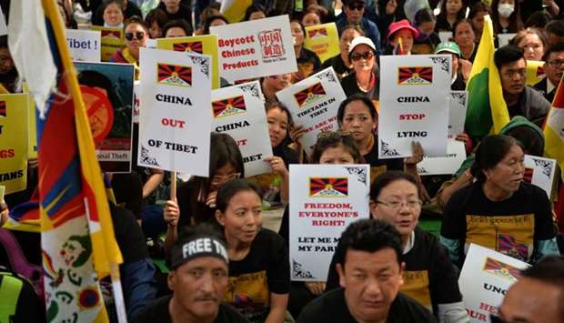 Exiled Tibetan activists hold placards during a protest marking the 60th anniversary of the 1959 Tibetan uprising against Chinese rule in the Indian capital New Delhi
