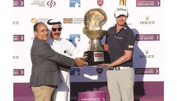 Commercial Bank Group CEO Joseph Abraham (left) and Qatar Golf Association (QGA) president Hassan al-Nuaimi (centre) present the Mother of Pearl Trophy to South African golfer Justin Harding after his win in the Commercial Bank Qatar Masters at the Doha Golf Club yesterday. PICTURES: Jayaram