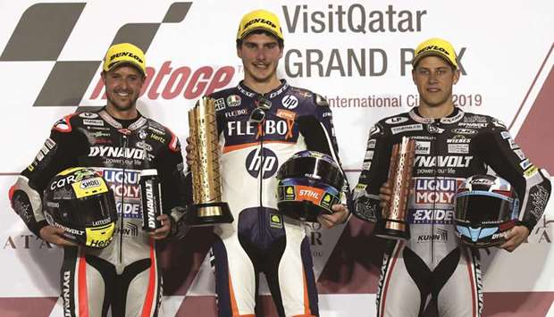 Flexboxu2019s Lorenzo Baldassarri (C) with his trophy after winning the Moto 2 race alongside second placed Dynavolt Intact GPu2019s Thomas Luthi (L) and third placed Dynavolt Intact GPu2019s Marcel Schrotter.