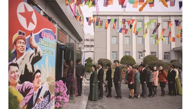 Voters queue to cast their ballots at the u20183.26 Pyongyang Cable Factoryu2019 during voting for Supreme Peopleu2019s Assembly elections, in Pyongyang yesterday.
