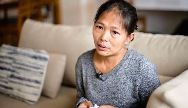 In this picture taken on March 5, 2019, Baby Jane Allas, a 38-year-old mother of five Filipina domestic worker who was sacked after she was diagnosed with cervical cancer, cries during an interview with AFP in Hong Kong