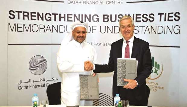 QFC Authority CEO Yousuf Mohamed al-Jaida and Pakistan Stock Exchange CEO Richard Morin shaking hands after signing the MoU on the sidelines of the Qatar-Pakistan Trade and Investment Conference in Doha yesterday.